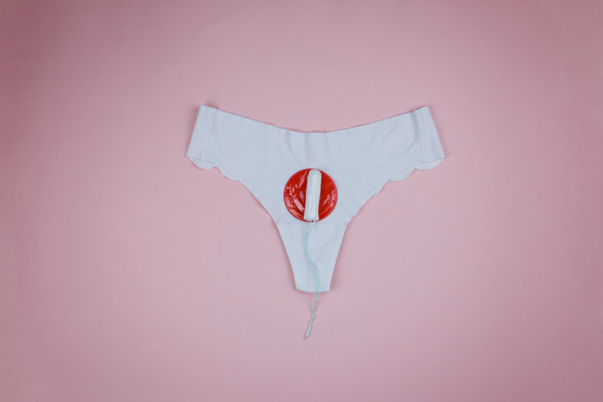 White panties and tampon indicating the arrival of menstruation